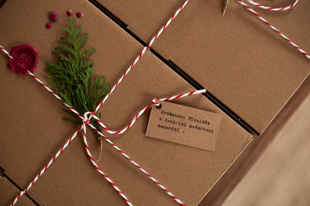 Gifts wrapped in kraft paper with twine and evergreen