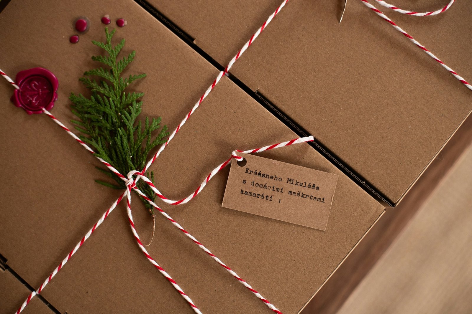 Gifts wrapped in kraft paper with twine and evergreen